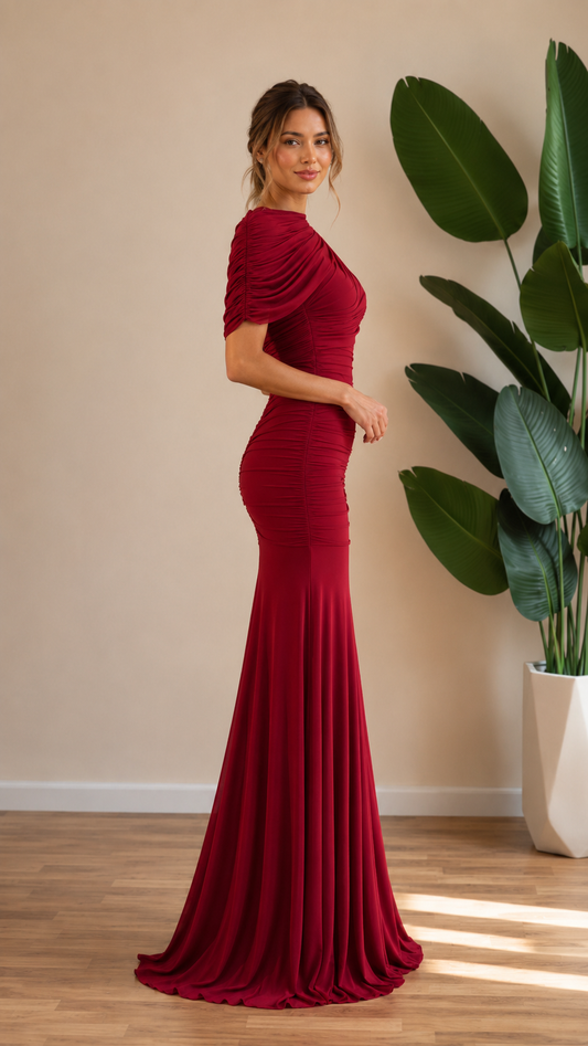 Side view of burgundy draped neckline mermaid evening gown