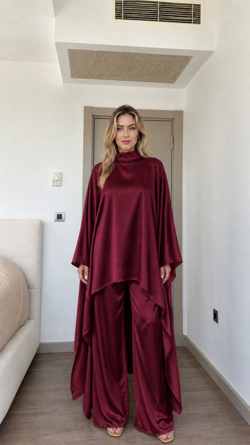 Front view of woman wearing Burgundy wine satin high neck cape tunic and wide-leg pants set
