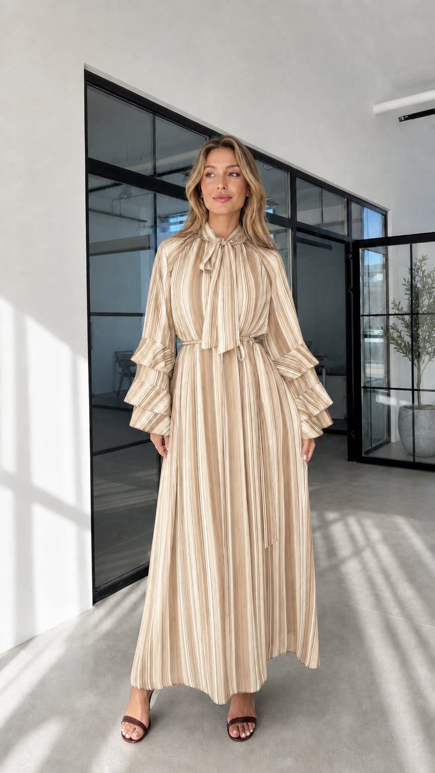Model wearing beige striped ruffle sleeve maxi dress front view
