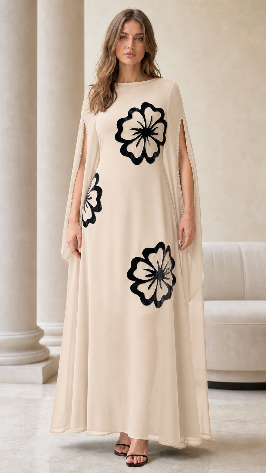 Champagne beige cape sleeve maxi dress with contrasting black floral motifs