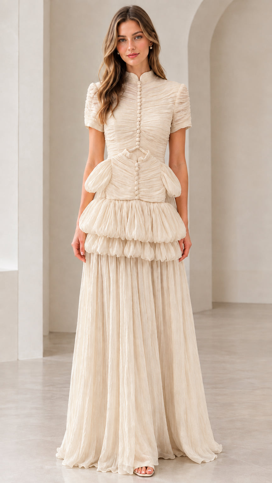 Front view of model wearing champagne beige mock neck tiered pleated maxi dress