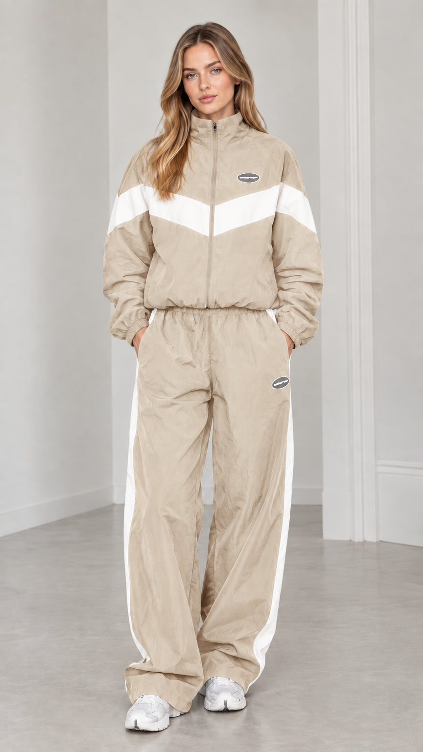 Full length view of woman wearing beige and white colorblock tracksuit set