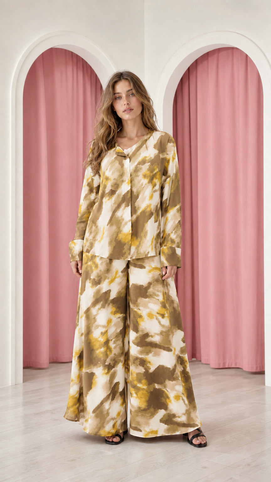Model wearing mustard yellow tie-dye satin top and wide-leg trousers set