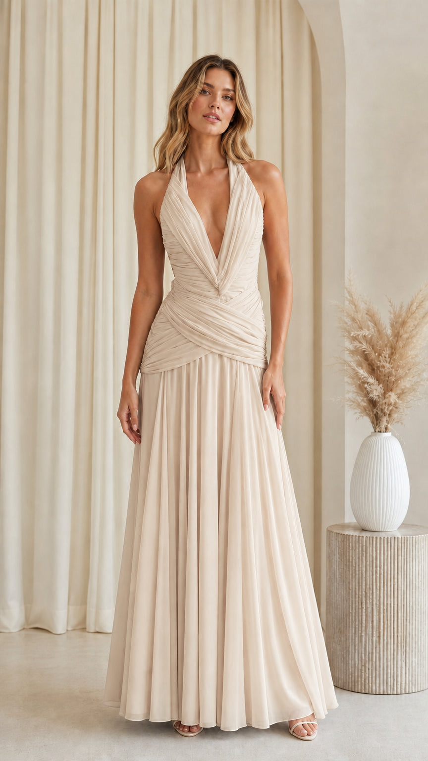 Front view of champagne beige halter plunging ruched waist pleated evening dress