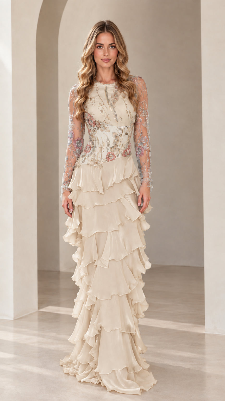 Front view of model wearing Champagne cream embroidered long sleeve tiered maxi gown