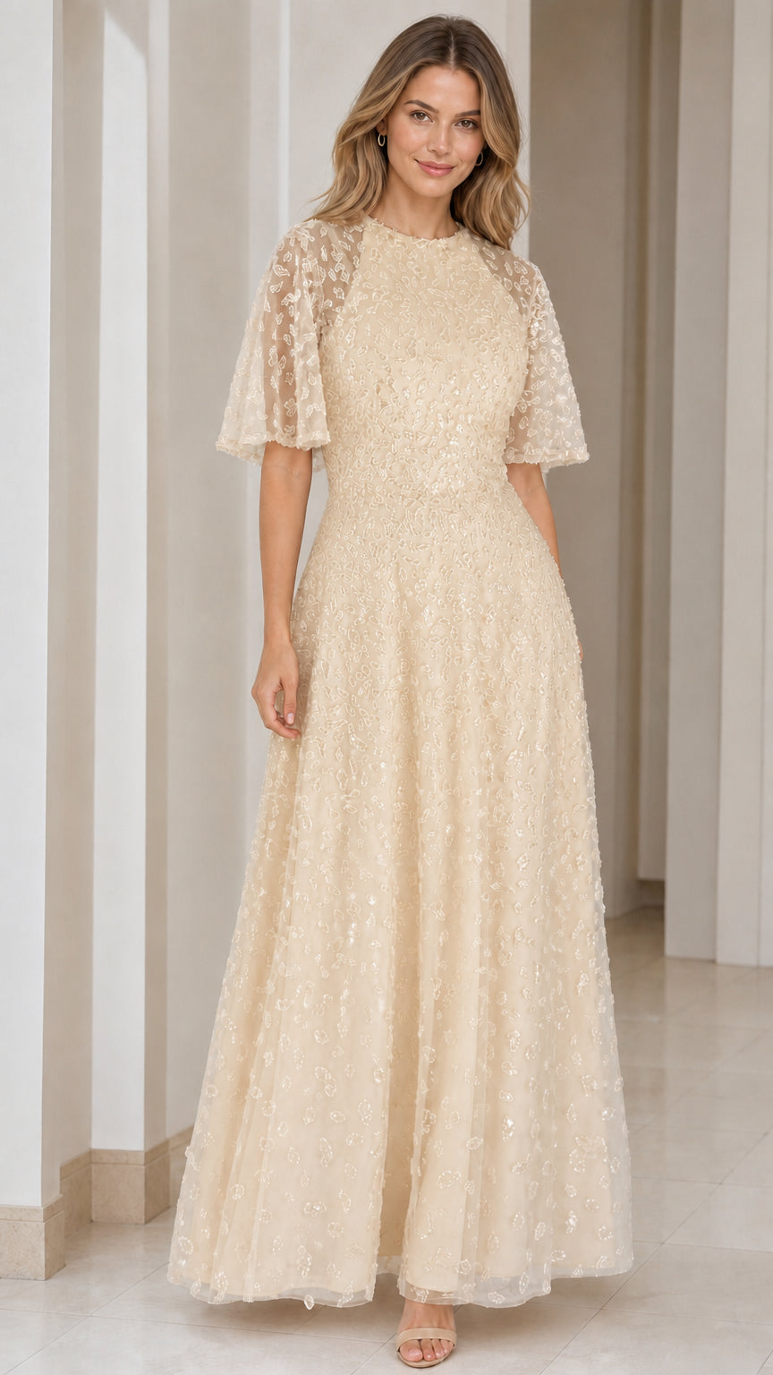 Woman wearing champagne gold sequin embroidered flutter sleeve maxi dress