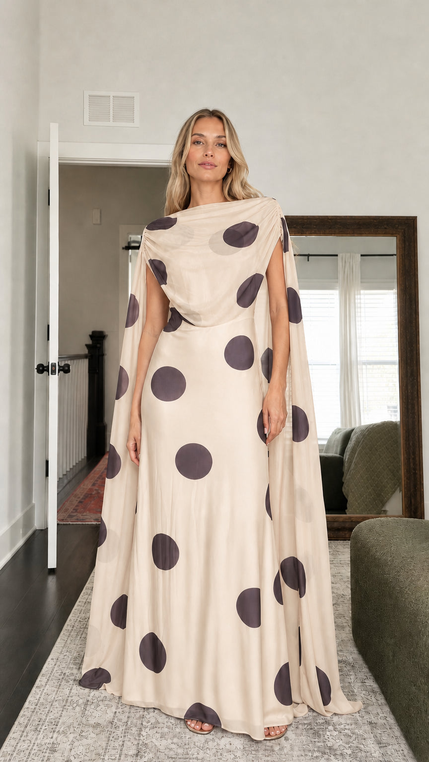 Model wearing beige polka dot cape maxi dress