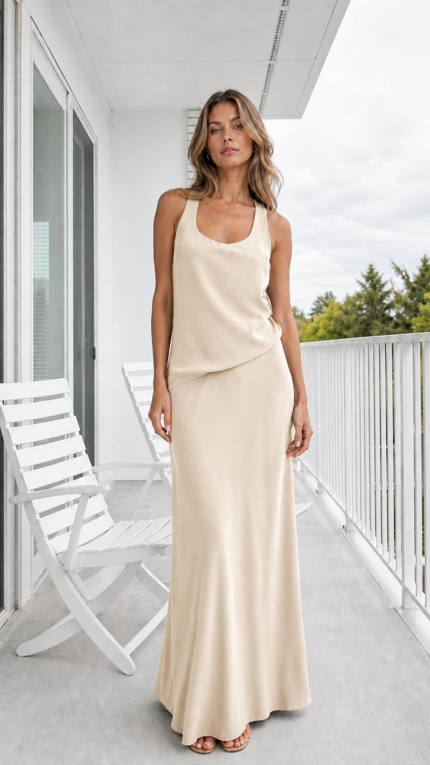 Model wearing champagne beige sleeveless draped maxi dress