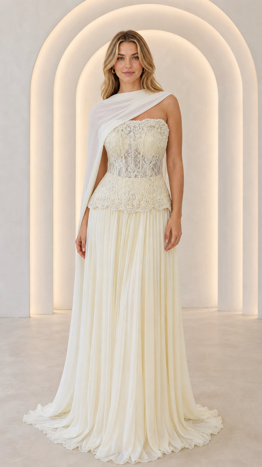 Ivory strapless lace corset maxi gown with pleated skirt and sheer shoulder drape - front view