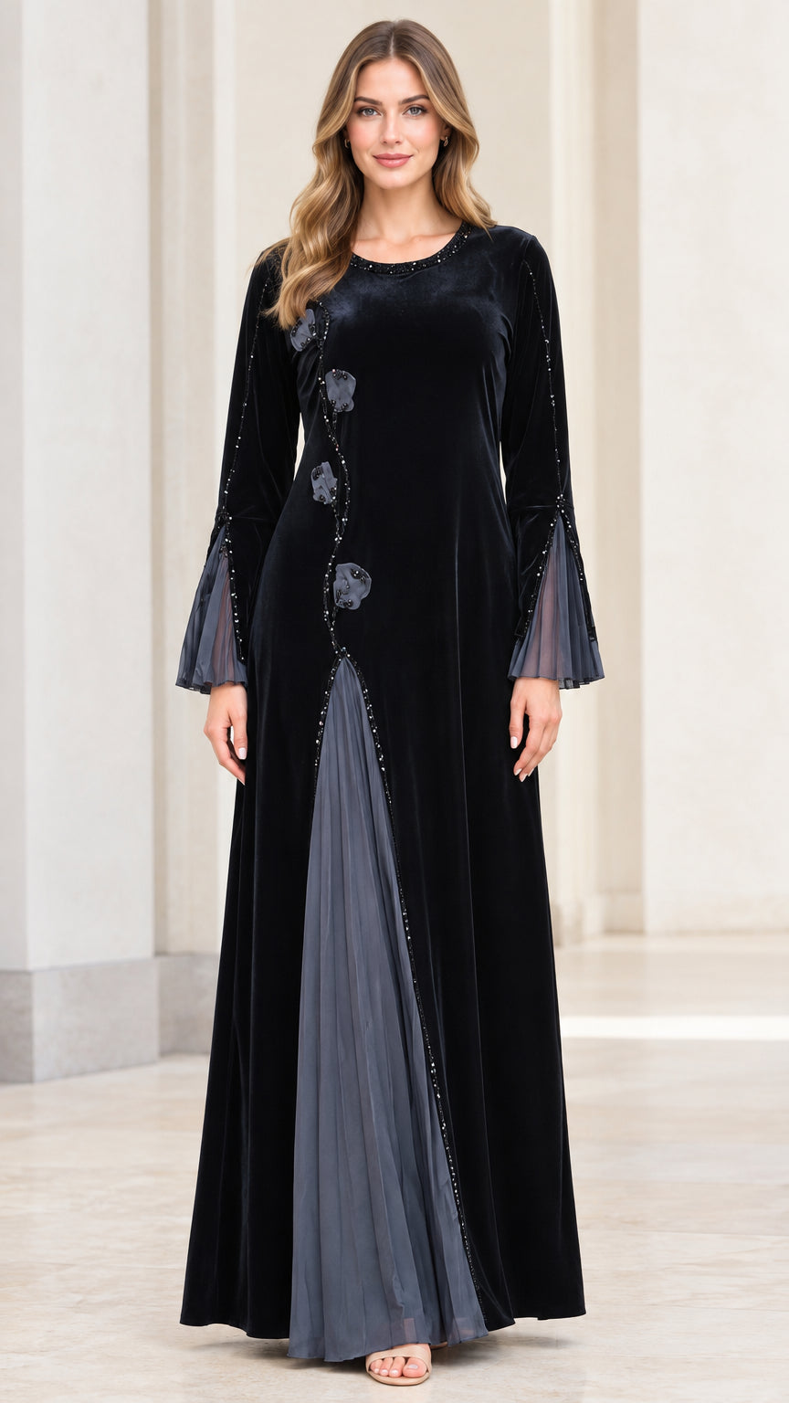 Black long sleeve velvet maxi dress with floral applique and pleated mesh insert front view
