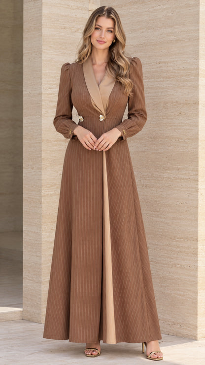 Front full view of woman wearing brown pinstripe maxi blazer dress with beige contrast lapel