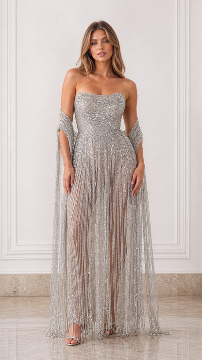 Front view of model wearing silver strapless beaded fringe evening gown with matching shawl