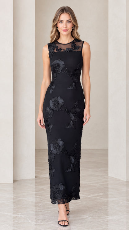 Front view of model wearing black floral appliqué sleeveless column maxi dress