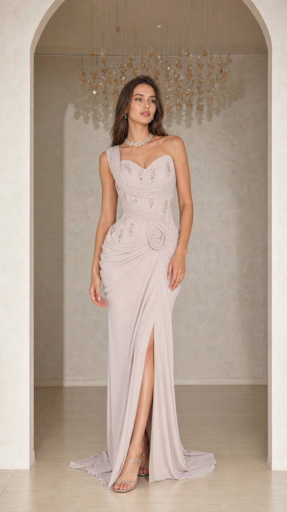 Front view of woman wearing silver grey one-shoulder beaded evening gown with slit