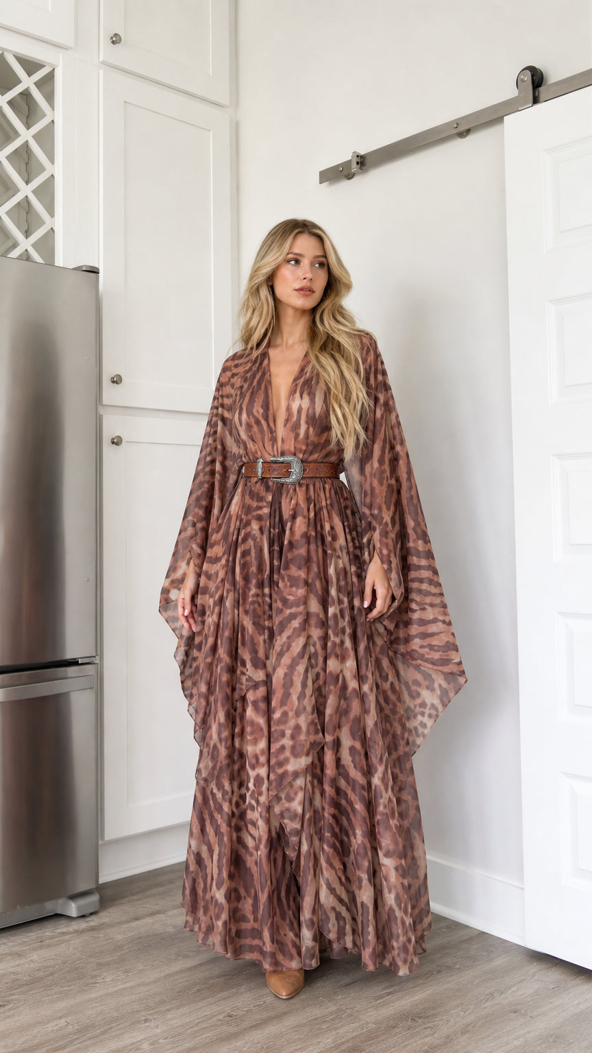 Front full-length view of woman wearing brown abstract animal print kimono maxi dress with western belt