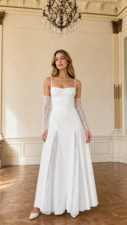 Front view of model wearing white bustier maxi gown with lace insets and lace gloves