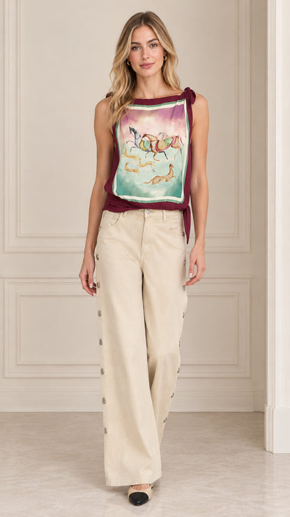 Women's scarf print tie shoulder tank top in burgundy paired with wide-leg beige pants front view