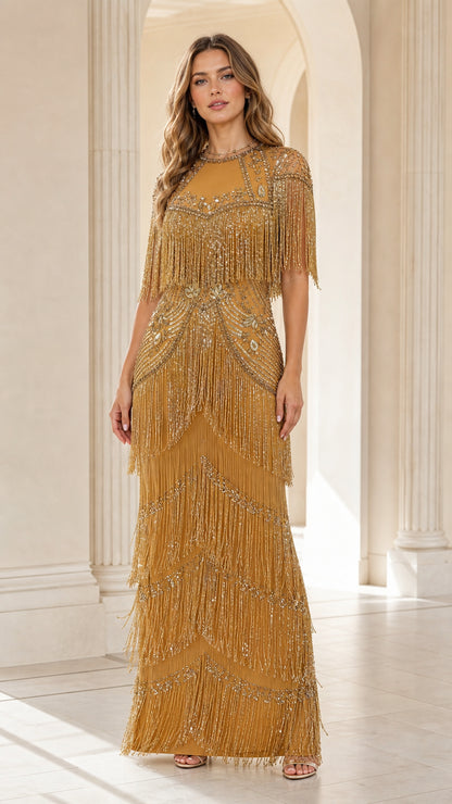 Full-length front view of woman wearing gold sequin beaded fringe maxi gown in an arched hallway