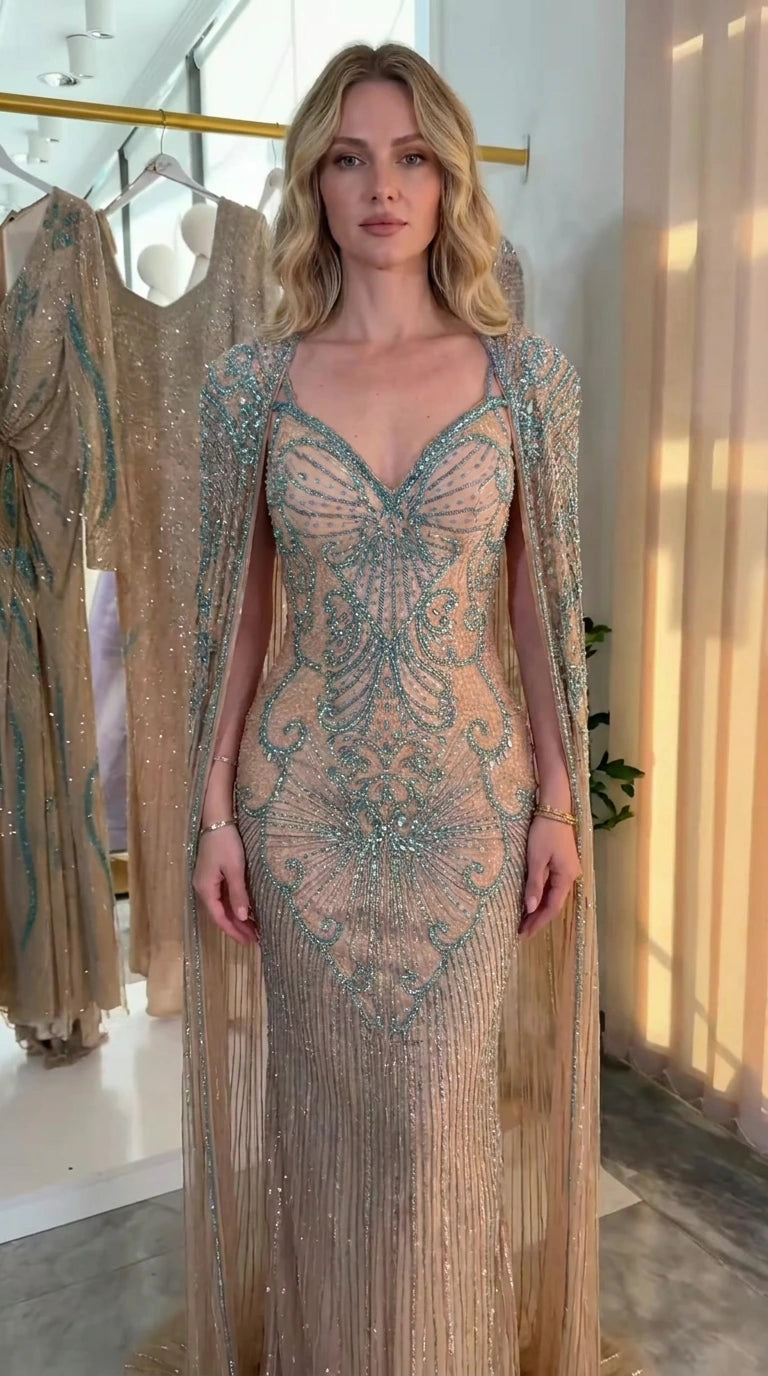 Front view of champagne beaded sweetheart gown with sweeping cape sleeves