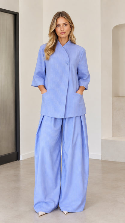 Women's light blue pinstripe two-piece set featuring asymmetric top and wide-leg pants front view