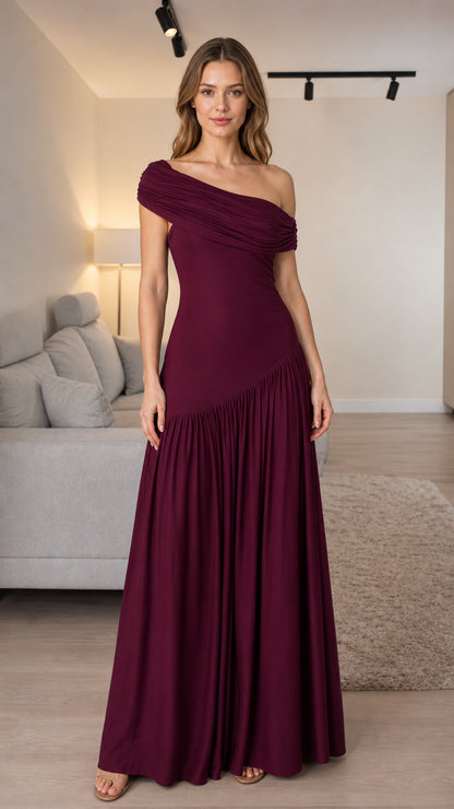 Front view of woman wearing burgundy one-shoulder pleated maxi dress