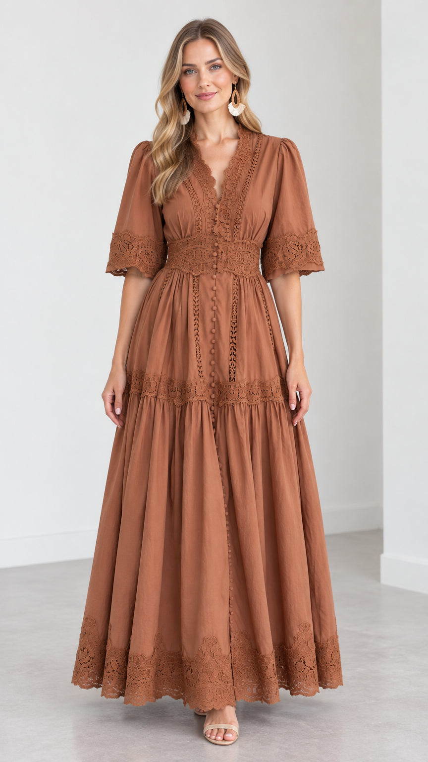 Front view of woman wearing a rust brown V-neck lace trim tiered maxi dress