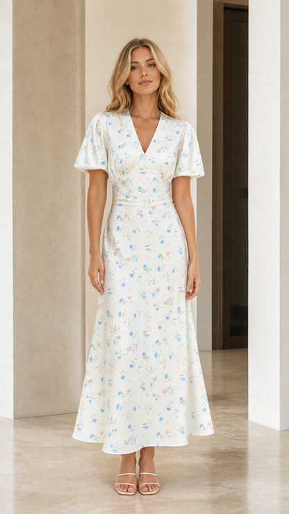 Front view of woman wearing white floral print maxi dress
