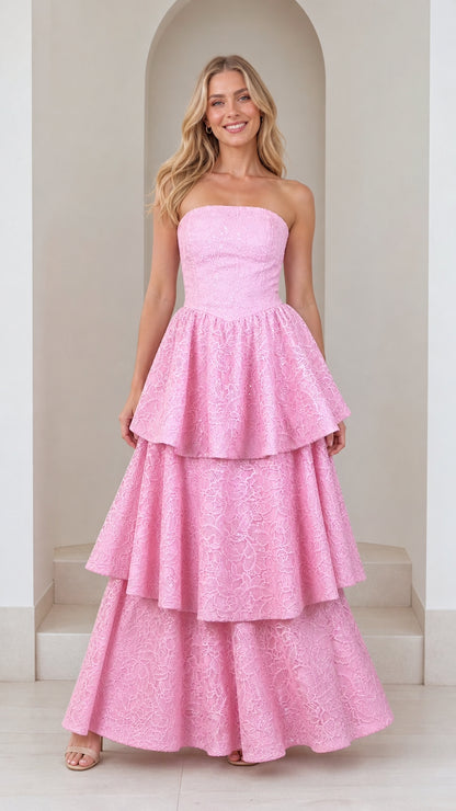 Front view of model wearing pink strapless tiered lace maxi dress