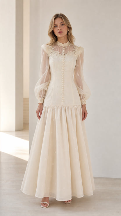 Model wearing Ivory long sleeve lace appliqué drop waist maxi dress front view