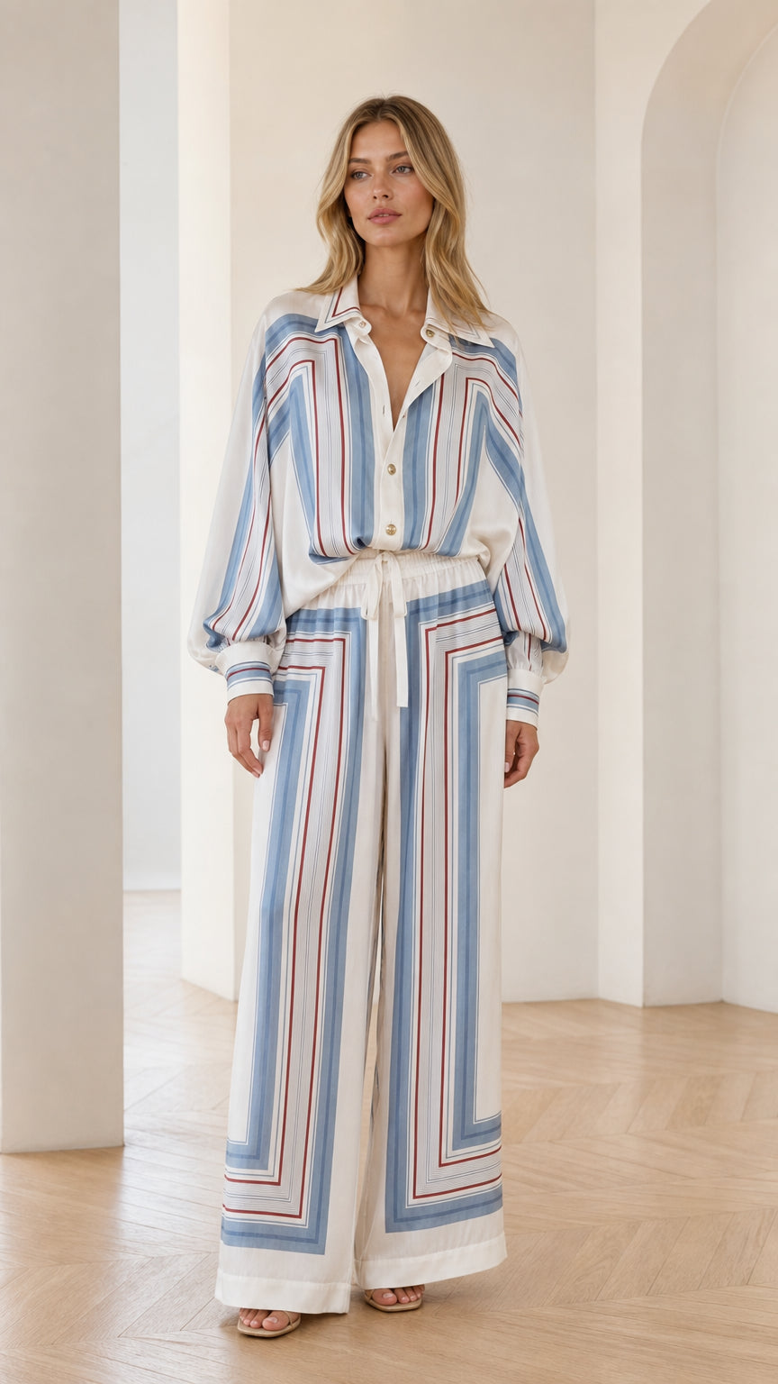 Front view of model wearing white geometric striped two-piece set