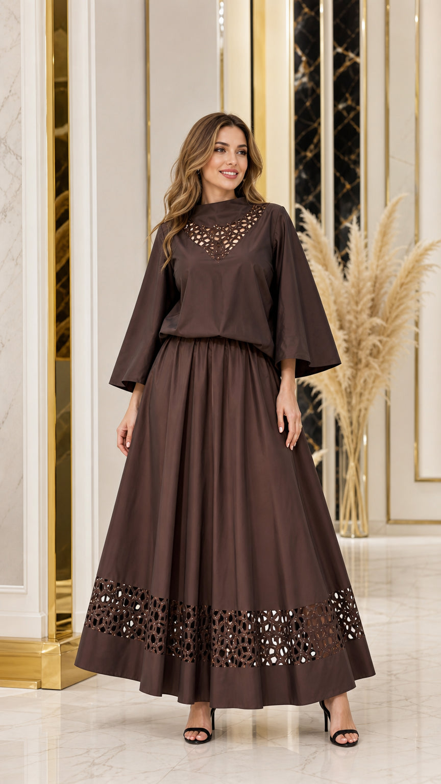 Front view of woman wearing chocolate brown cutout neckline top and maxi skirt set