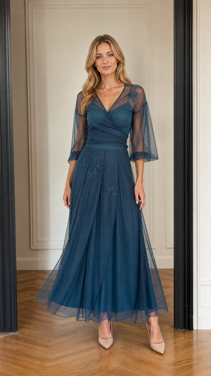 Front full-length view of teal blue floral embroidered tulle maxi evening dress