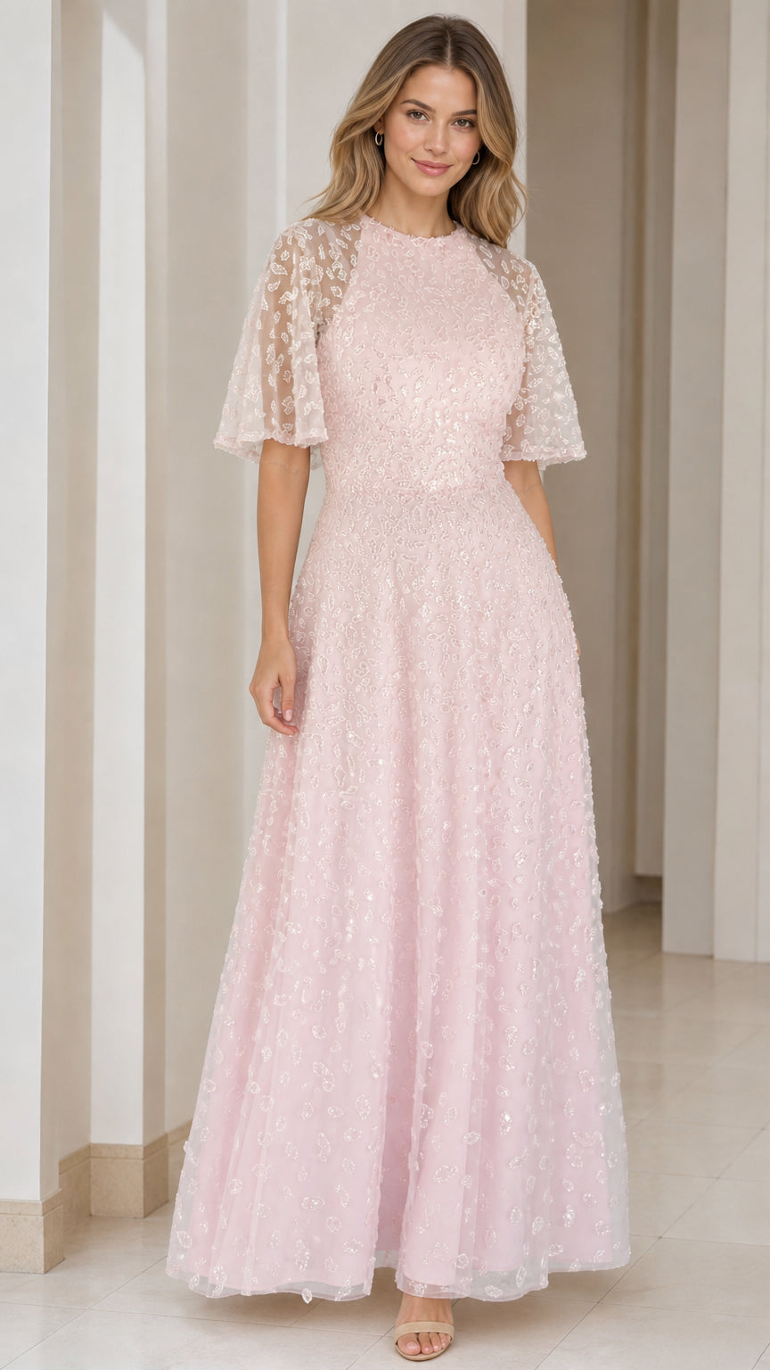 Front view of woman wearing blush pink sequin embroidered flutter sleeve maxi gown