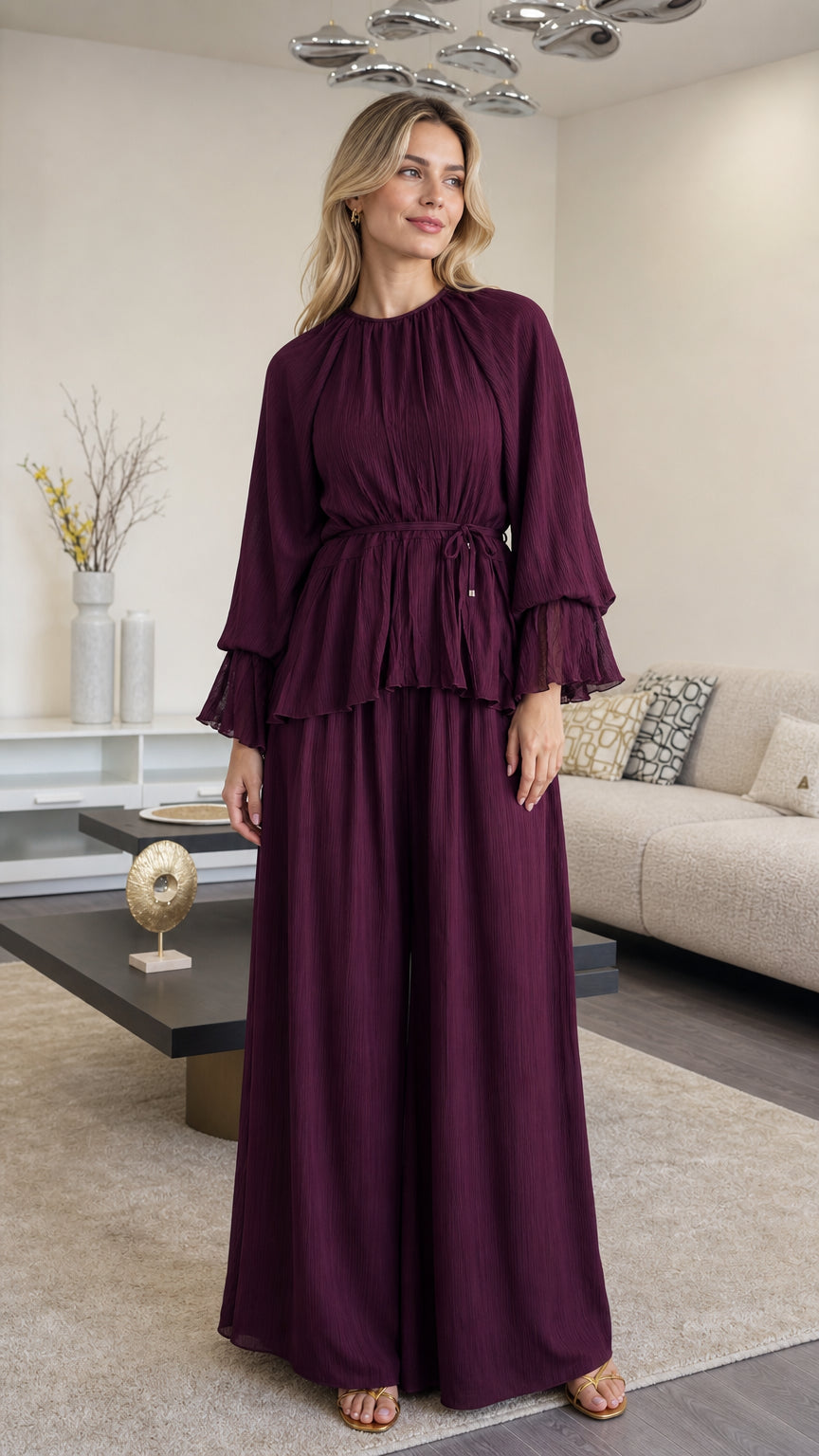Front full view of woman wearing Plum pleated peplum top and wide leg pants set