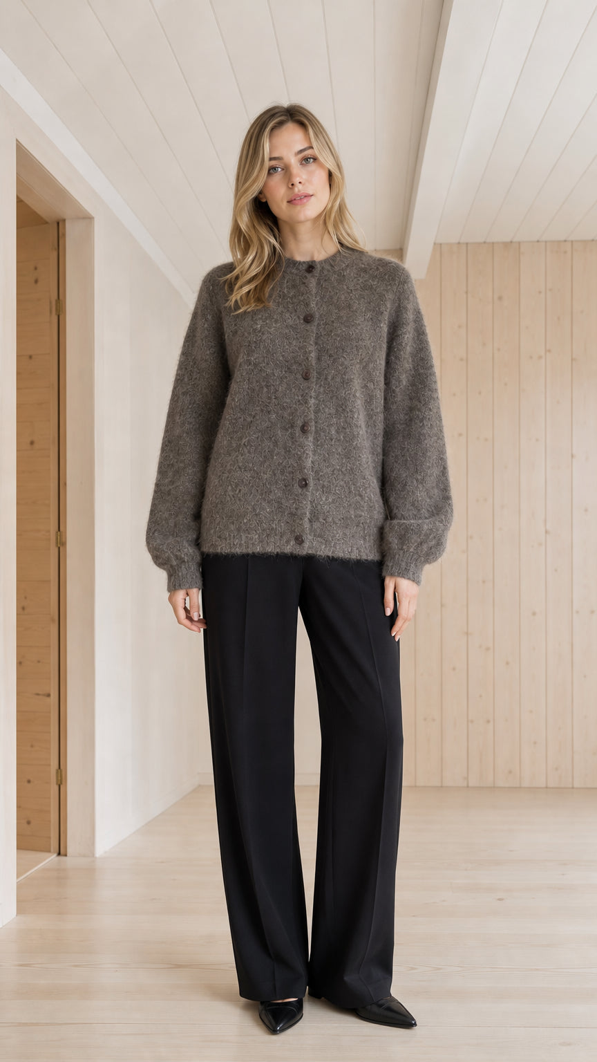 Front view of model wearing charcoal grey fuzzy crewneck cardigan sweater
