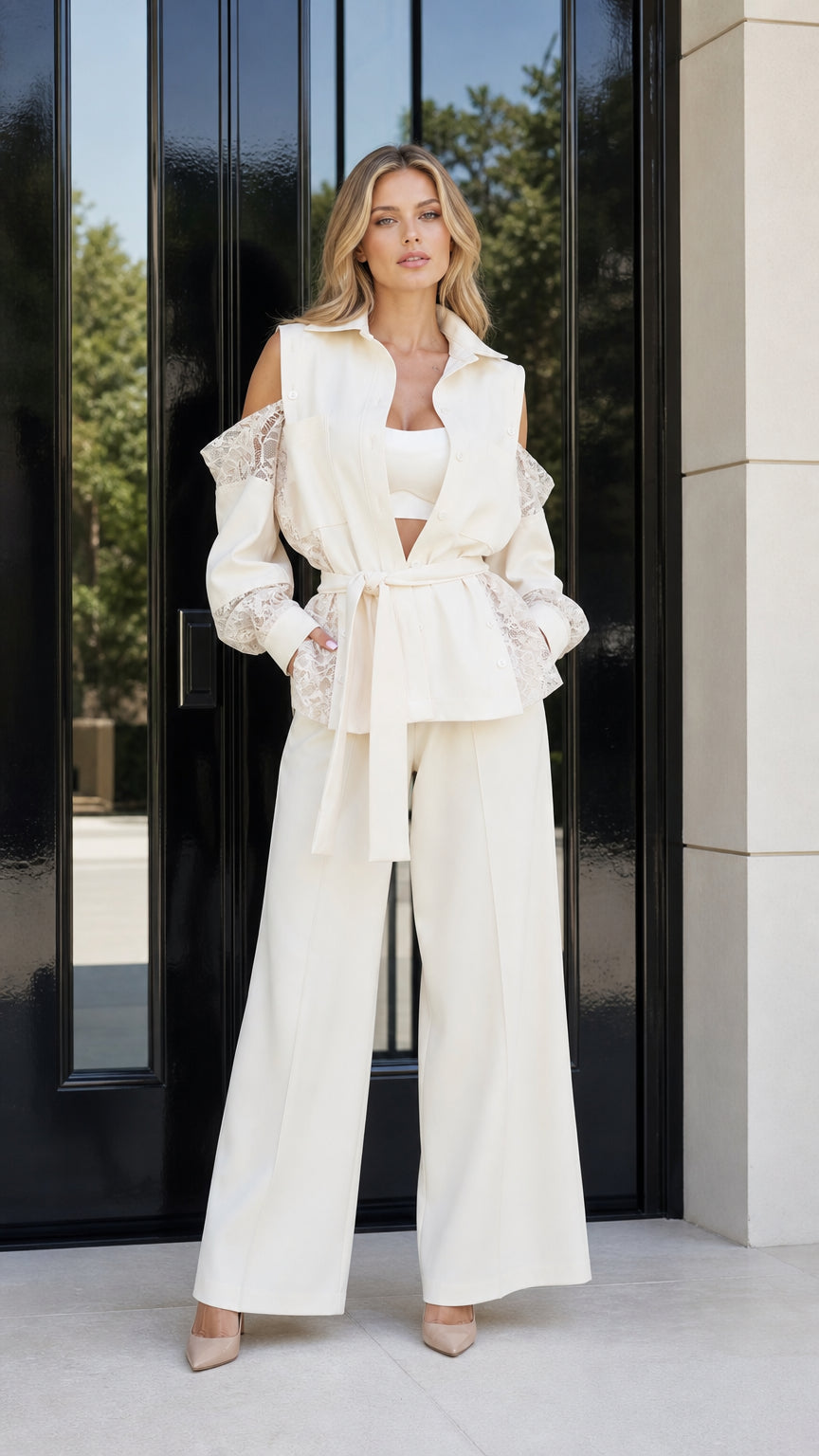 Model wearing cream cold shoulder lace blazer and matching wide leg trousers front view
