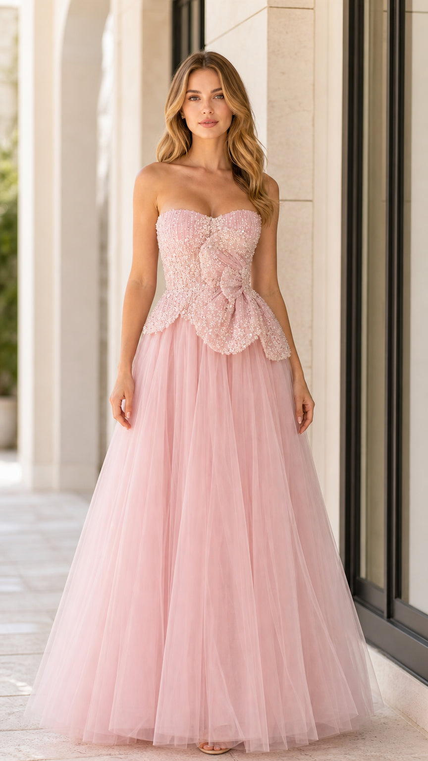 Front full-length view of woman in blush pink strapless beaded tulle ball gown