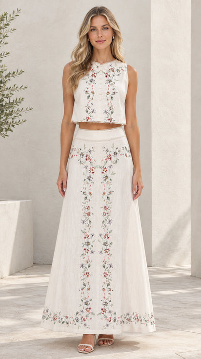 White floral embroidered sleeveless crop top and maxi skirt two-piece set front view