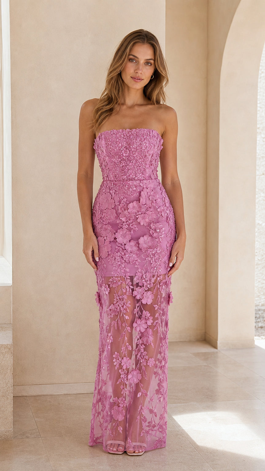 Front view of woman wearing strapless orchid pink 3D floral lace maxi dress with sheer hem