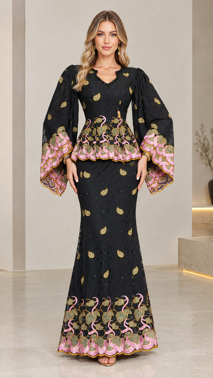 Front view of model wearing black embroidered peplum maxi dress with flared sleeves