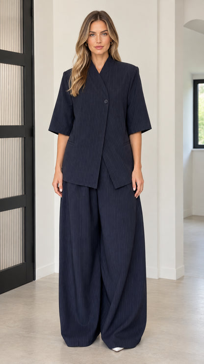 Front full-length view of model wearing Navy Blue asymmetric blazer and wide-leg pants set