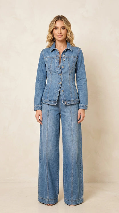 Front view of a woman wearing a medium wash blue denim-style jacket and matching wide-leg pants set