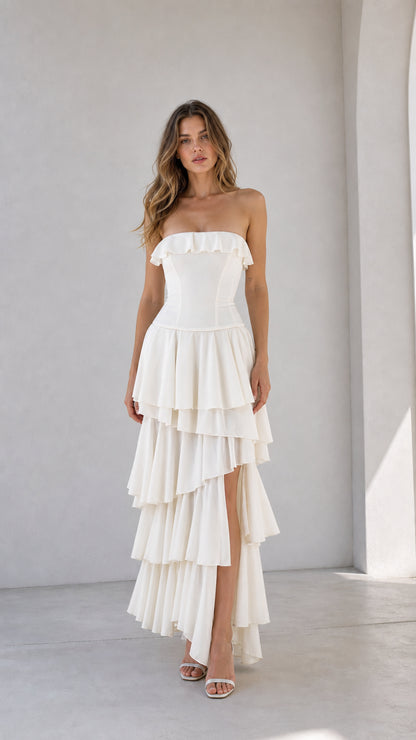 Front view of woman wearing white strapless ruffled tiered maxi dress