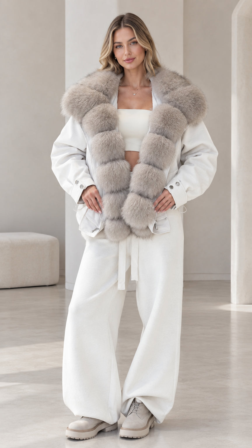Front view of model wearing white zip-up jacket with grey plush faux fur collar and matching wide-leg pants