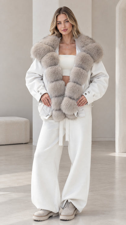 Front view of model wearing white zip-up jacket with grey plush faux fur collar and matching wide-leg pants