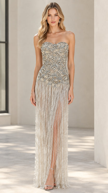 Front view of Champagne strapless beaded fringe evening gown with slit