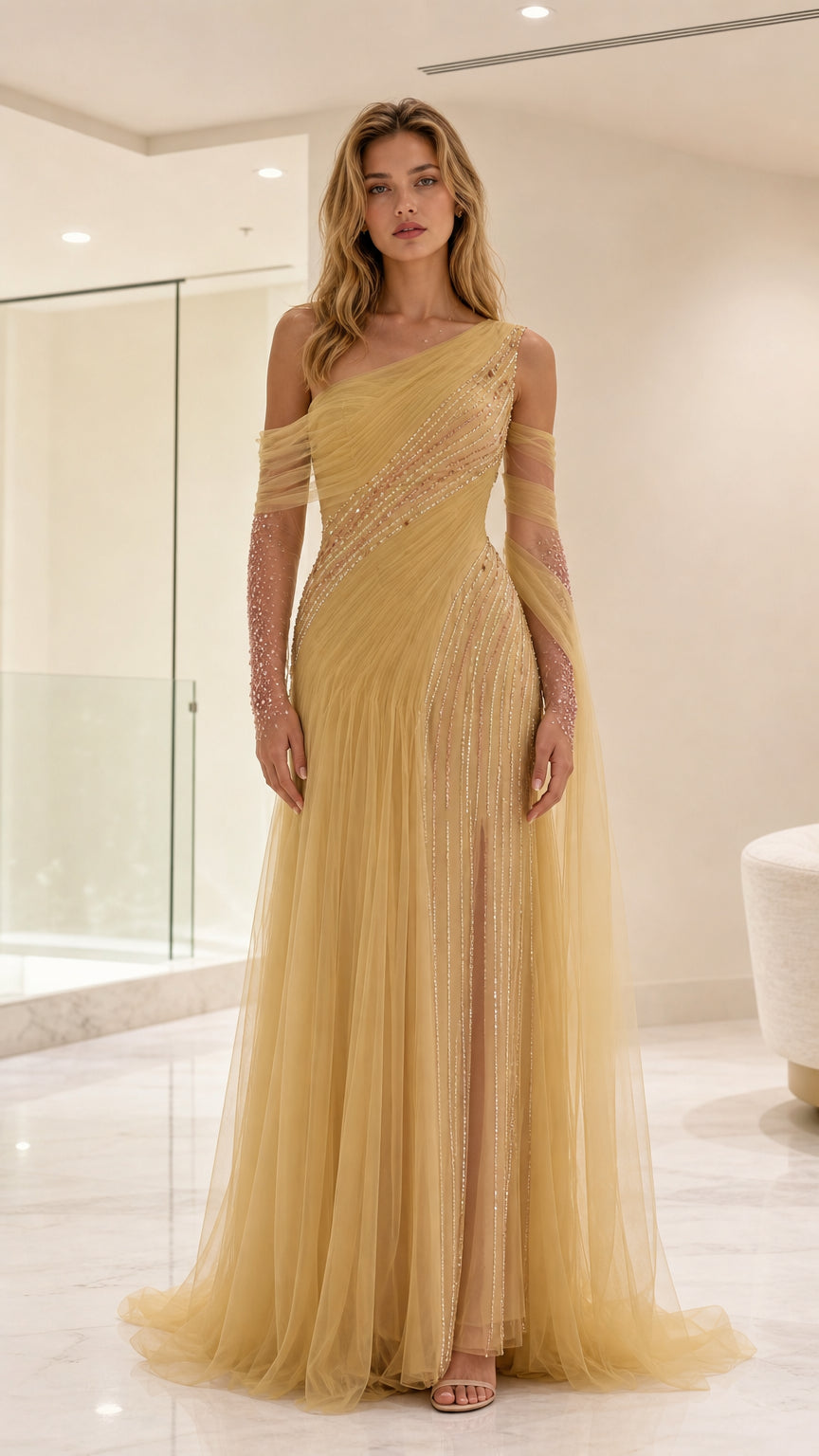 Front view of model wearing gold one-shoulder sequin embellished tulle evening gown with draped sleeves