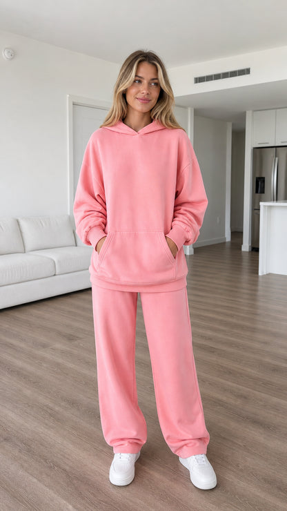 Front view of model wearing pink oversized hoodie and sweatpants set