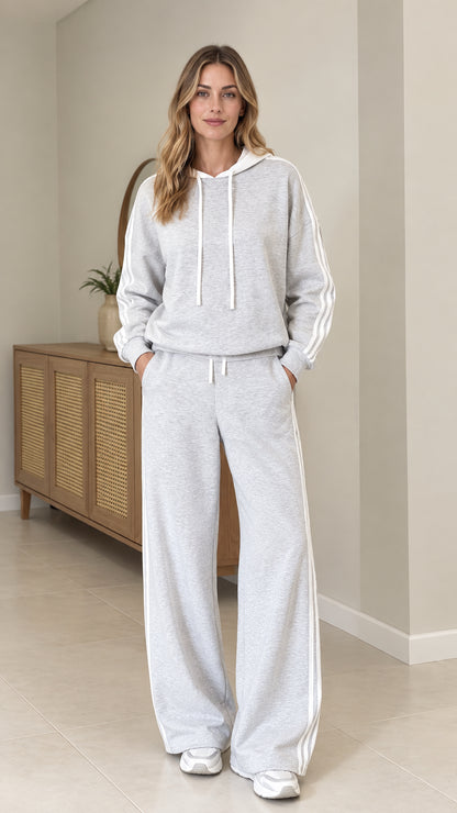 Front view of model wearing light Heather Grey two-piece hoodie and wide leg pants tracksuit set