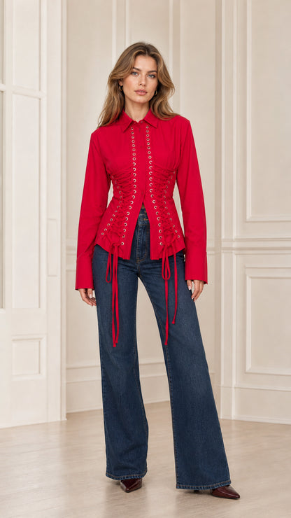 Front full-length view of woman wearing red lace-up corset button-down shirt with wide leg jeans